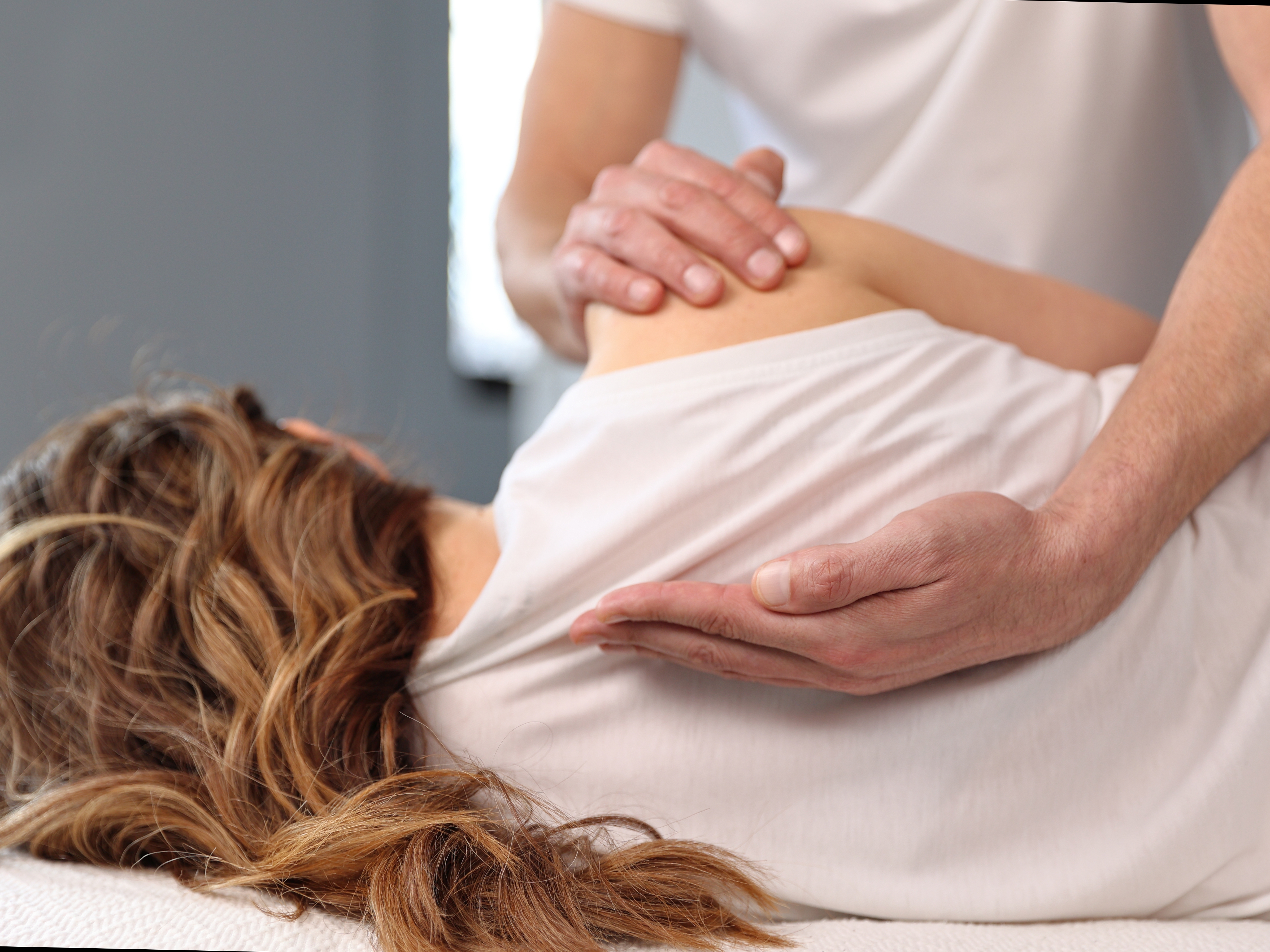 Osteopath working on woman's back Osteopath working on woman's back