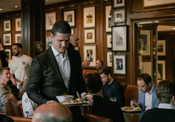 Men eating and carrying on in the Oak Room at the Cambridge Club following our squash championships