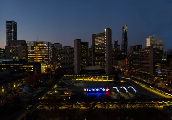 View of Toronto's City Hall, Nathan Phillips Square, and the Toronto sign from the Cambridge Club's Oak Room at twilight